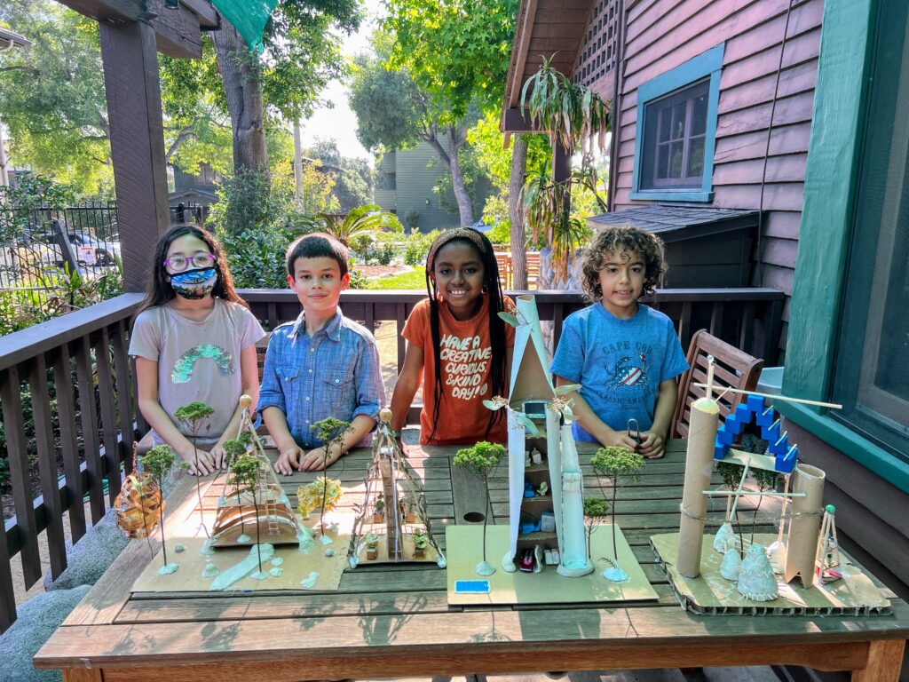 Institute for Educational Advancement Academy students showing off their bio-architecture projects at the Learning Center